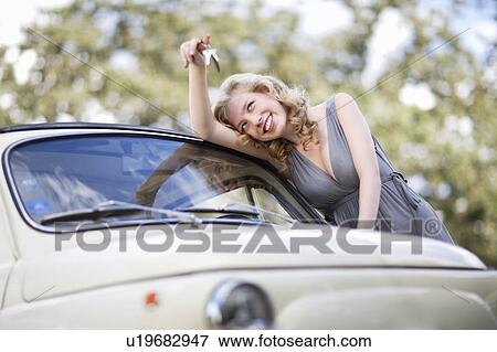 Girl holding car keys in her hand View Large Photo Image Stock Photo - Girl holding car keys in her hand. Fotosearch