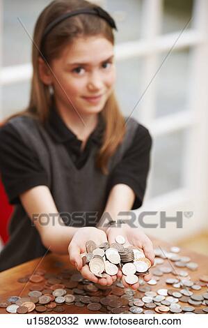 Girl holding coins in her hands View Large Photo Image Stock Image - Girl holding coins in her hands. Fotosearch