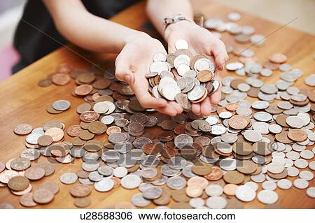 Girl holding coins in her hands View Large Photo Image Stock Photograph - Girl holding coins in her hands. Fotosearch