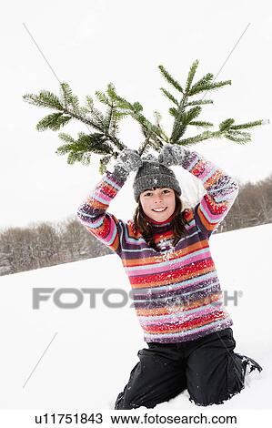 Girl holding fir branches on her head View Large Photo Image Stock Image - Girl holding fir branches on her head. Fotosearch