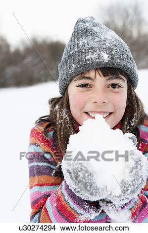 Picture - Girl holding snow in her hands. Fotosearch