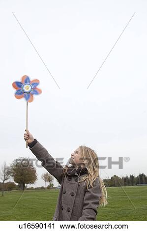 Girl holding wind wheel View Large Photo Image Stock Image - Girl holding wind wheel. Fotosearch