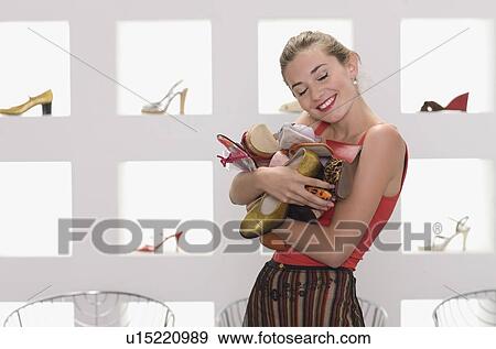 Stock Photo - Girl in a shoe shop. Fotosearch