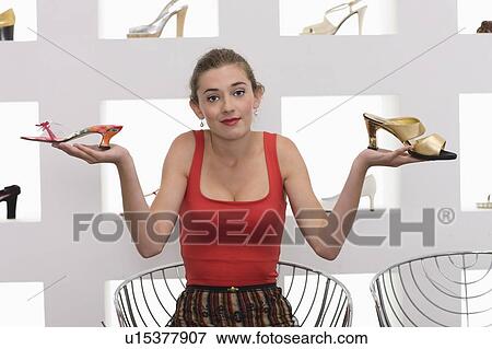 Stock Photo - Girl in a shoe shop. Fotosearch