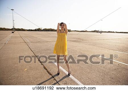 Stock Image - Girl in parking lot. Fotosearch