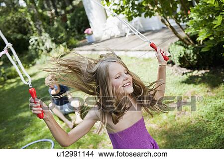 Girl jumping rope in garden View Large Photo Image Picture - Girl jumping rope in garden. Fotosearch