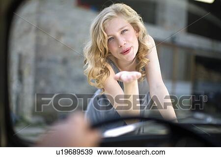 Girl kissing man in in car View Large Photo Image Stock Photo - Girl kissing man in in car. Fotosearch
