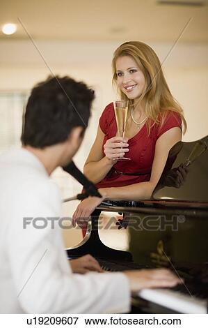 Girl leaning on piano View Large Photo Image Stock Photo - Girl leaning on piano. Fotosearch