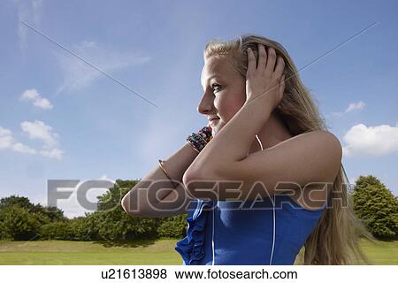 Girl listening to headphones View Large Photo Image Stock Photo - Girl listening to headphones. Fotosearch