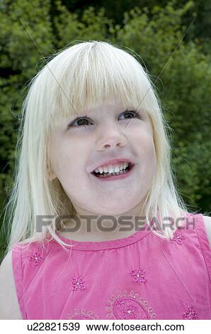 Stock Photo - Girl looking up to the sky. Fotosearch
