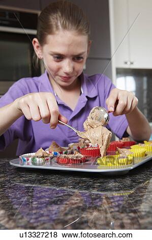 Stock Photo - Girl making cakes in the kitchen. Fotosearch