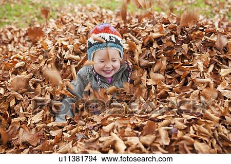Girl playing in the leaves View Large Photo Image Picture - Girl playing in the leaves. Fotosearch