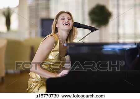 Girl playing the piano View Large Photo Image Stock Photo - Girl playing the piano. Fotosearch