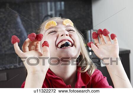 Girl playing with fruit View Large Photo Image Stock Image - Girl playing with fruit. Fotosearch