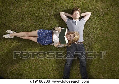 Stock Photograph - Girl reading on a boys lap. Fotosearch