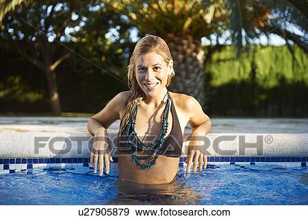 Girl relaxing in swimming pool View Large Photo Image Stock Photo - Girl relaxing in swimming pool. Fotosearch