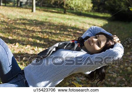 Girl relaxing in the sunshine View Large Photo Image Stock Photograph - Girl relaxing in the sunshine. Fotosearch