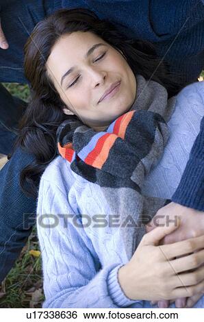 Girl resting on man's lap View Large Photo Image Stock Photograph - Girl resting on man's lap. Fotosearch