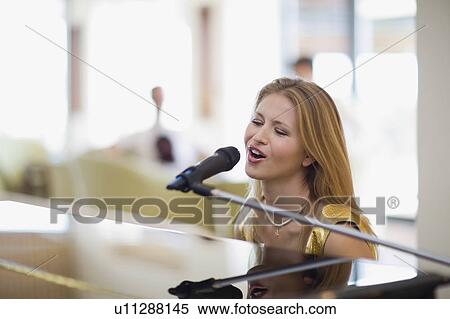 Girl singing and playing piano View Large Photo Image Stock Photography - Girl singing and playing piano. Fotosearch