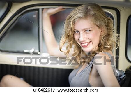 Girl sitting in a car View Large Photo Image Stock Photo - Girl sitting in a car. Fotosearch