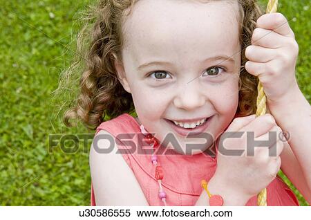 Girl smiling on swing View Large Photo Image Stock Photography - Girl smiling on swing. Fotosearch