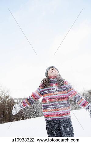 Girl standing in flurry of snow View Large Photo Image Stock Image - Girl standing in flurry of snow. Fotosearch
