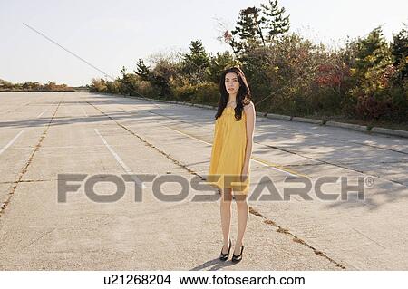 Girl standing in parking lot View Large Photo Image Picture - Girl standing in parking lot. Fotosearch