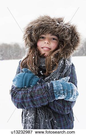 Girl standing in snow freezing View Large Photo Image Stock Photo - Girl standing in snow freezing. Fotosearch