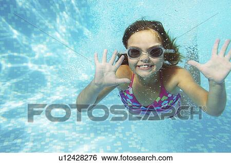 Girl swimming underwater View Large Photo Image Stock Photograph - Girl swimming underwater. Fotosearch