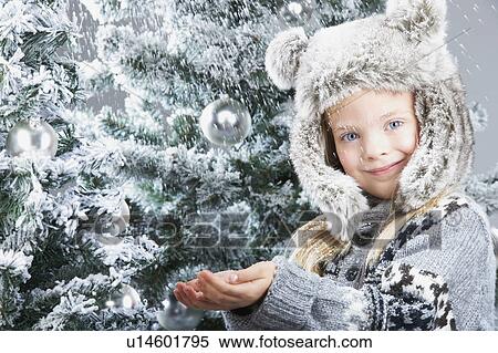 Girl under the snow, by christmas trees View Large Photo Image Stock Photography - Girl under the snow, by christmas trees. Fotosearch