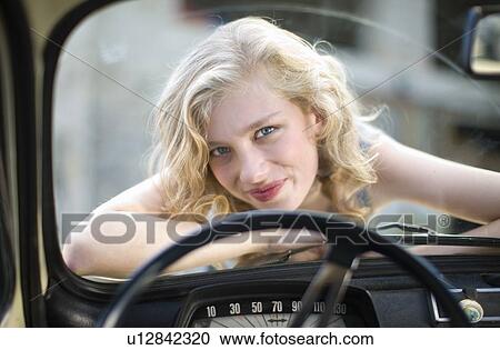 Girl up on a car View Large Photo Image Stock Image - Girl up on a car. Fotosearch