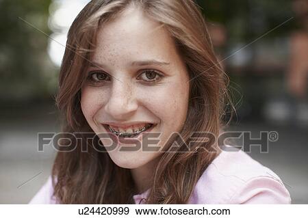 Girl with braces smiling into camera View Large Photo Image Stock Photo - Girl with braces smiling into camera. Fotosearch