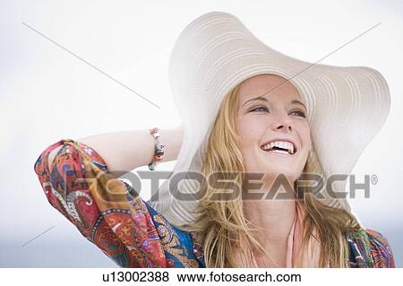 Stock Photo - Girl with floppy hat. Fotosearch