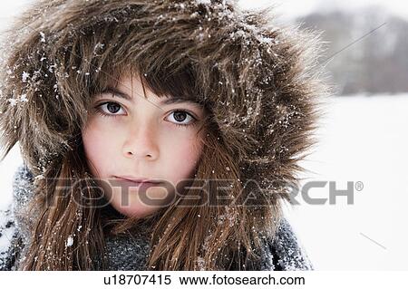 Stock Photography - Girl with fur cap looking to camera. Fotosearch