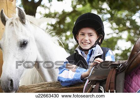 Stock Image - Girl with her pony. Fotosearch