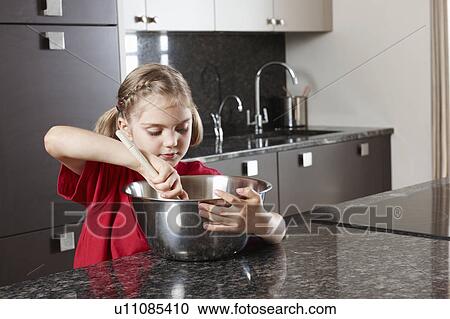Stock Image - Girl with mixing bowl. Fotosearch