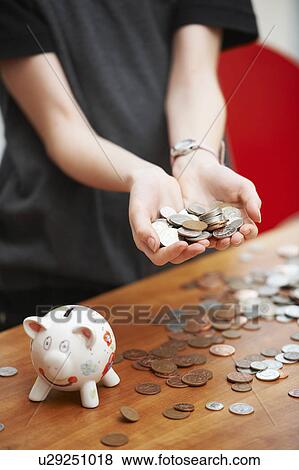 Girl with piggy bank holding coins View Large Photo Image Stock Photo - Girl with piggy bank holding coins. Fotosearch