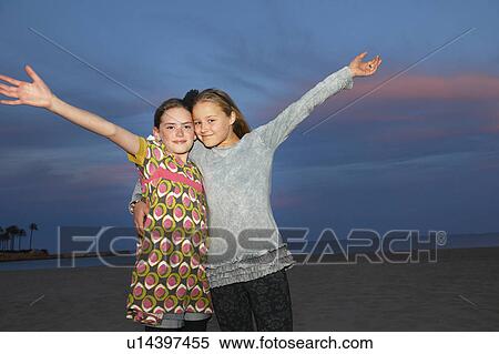 Girls at sunset on the beach View Large Photo Image Stock Photography - Girls at sunset on the beach. Fotosearch