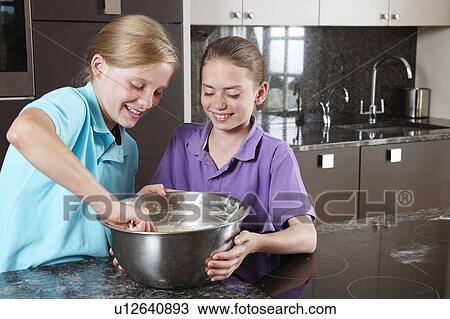 Girls cooking in the kitchen View Large Photo Image Stock Image - Girls cooking in the kitchen. Fotosearch