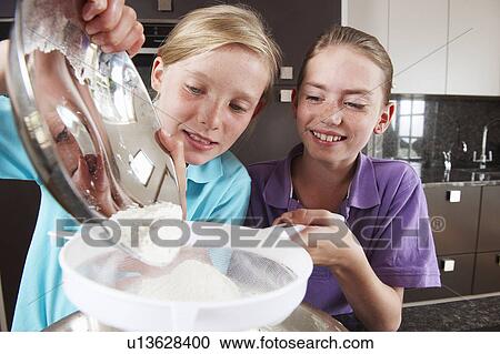 Girls cooking in the kitchen View Large Photo Image Stock Image - Girls cooking in the kitchen. Fotosearch