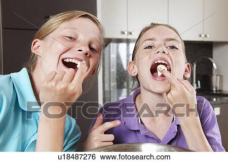 Girls cooking in the kitchen View Large Photo Image Stock Photograph - Girls cooking in the kitchen. Fotosearch