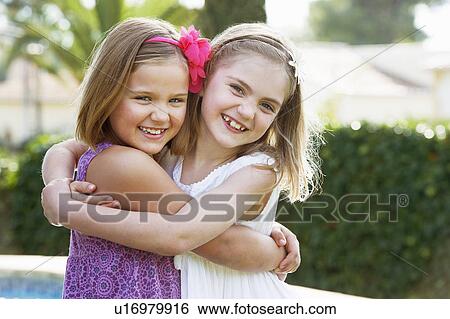 Girls hugging eachother View Large Photo Image Stock Photograph - Girls hugging eachother. Fotosearch