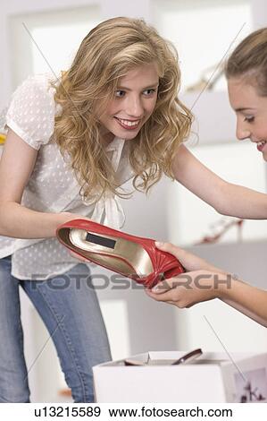 Stock Photo - Girls in a shoe shop. Fotosearch