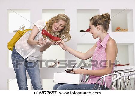 Girls in a shoe shop View Large Photo Image Stock Photo - Girls in a shoe shop. Fotosearch