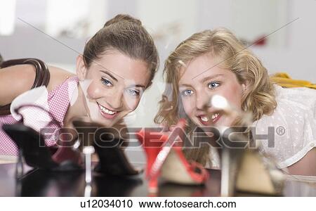 Girls in shoe shop View Large Photo Image Stock Image - Girls in shoe shop. Fotosearch