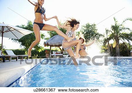 Stock Photo - Girls jumping into swimming pool. Fotosearch