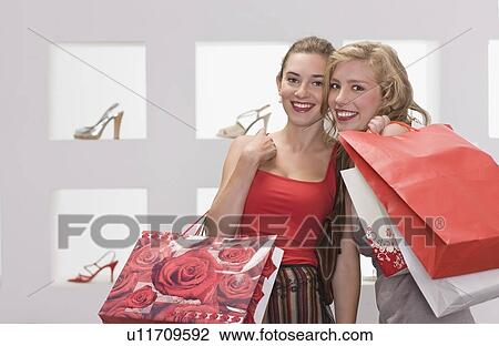 Stock Image - Girls on shopping tour. Fotosearch