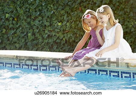 Girls playing by the pool View Large Photo Image Picture - Girls playing by the pool. Fotosearch