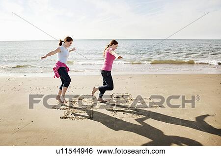 Girls playing hopscotch on beach View Large Photo Image Stock Photograph - Girls playing hopscotch on beach. Fotosearch