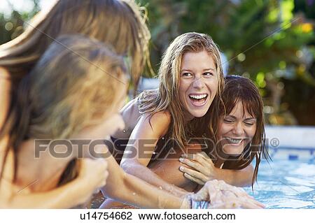 Girls playing in swimming pool View Large Photo Image Stock Image - Girls playing in swimming pool. Fotosearch